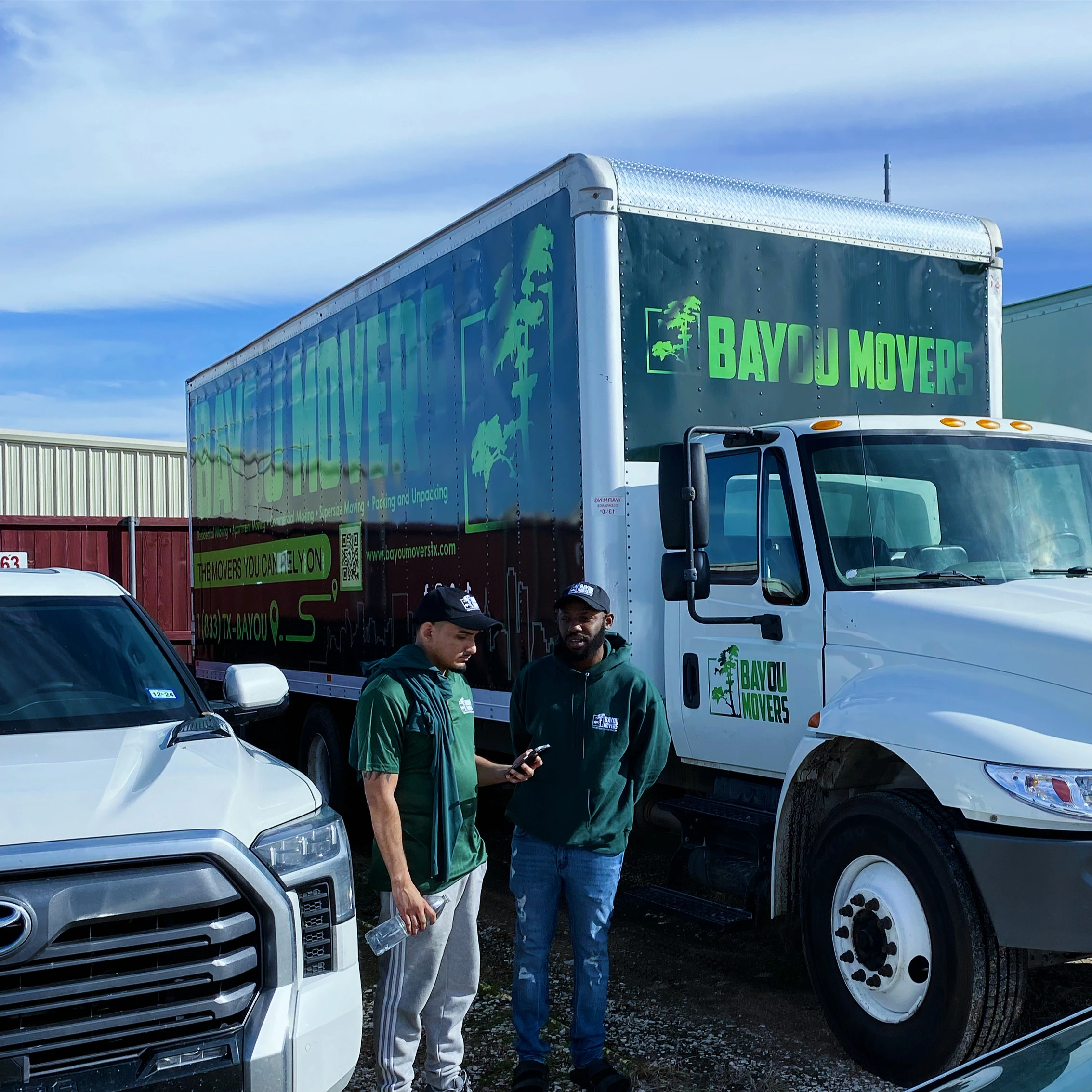 Bayou Movers crew coordinating beside a moving truck