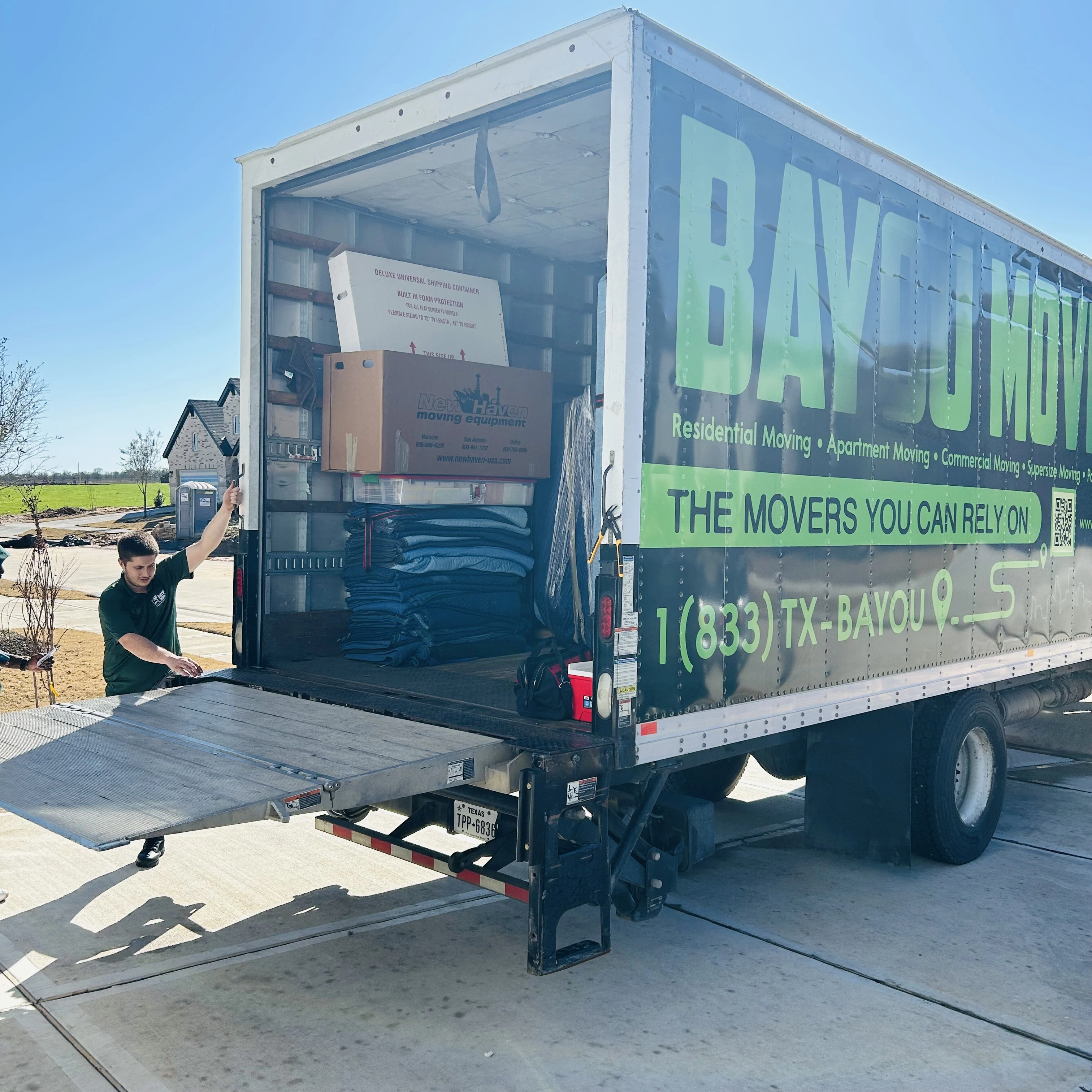 Bayou Movers crew loading protected items at a residential move