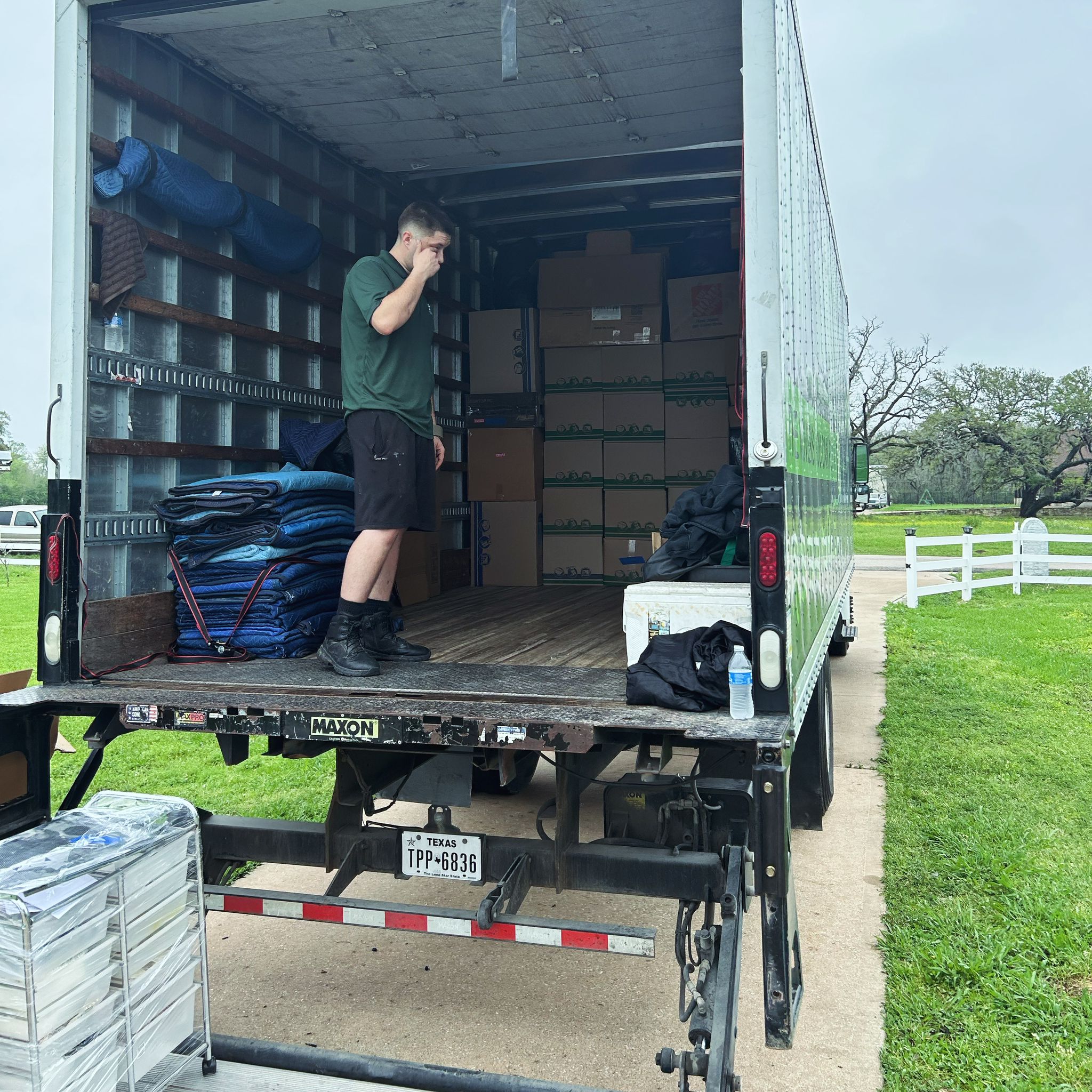 Bayou Movers crew member organizing boxes and blankets inside the truck