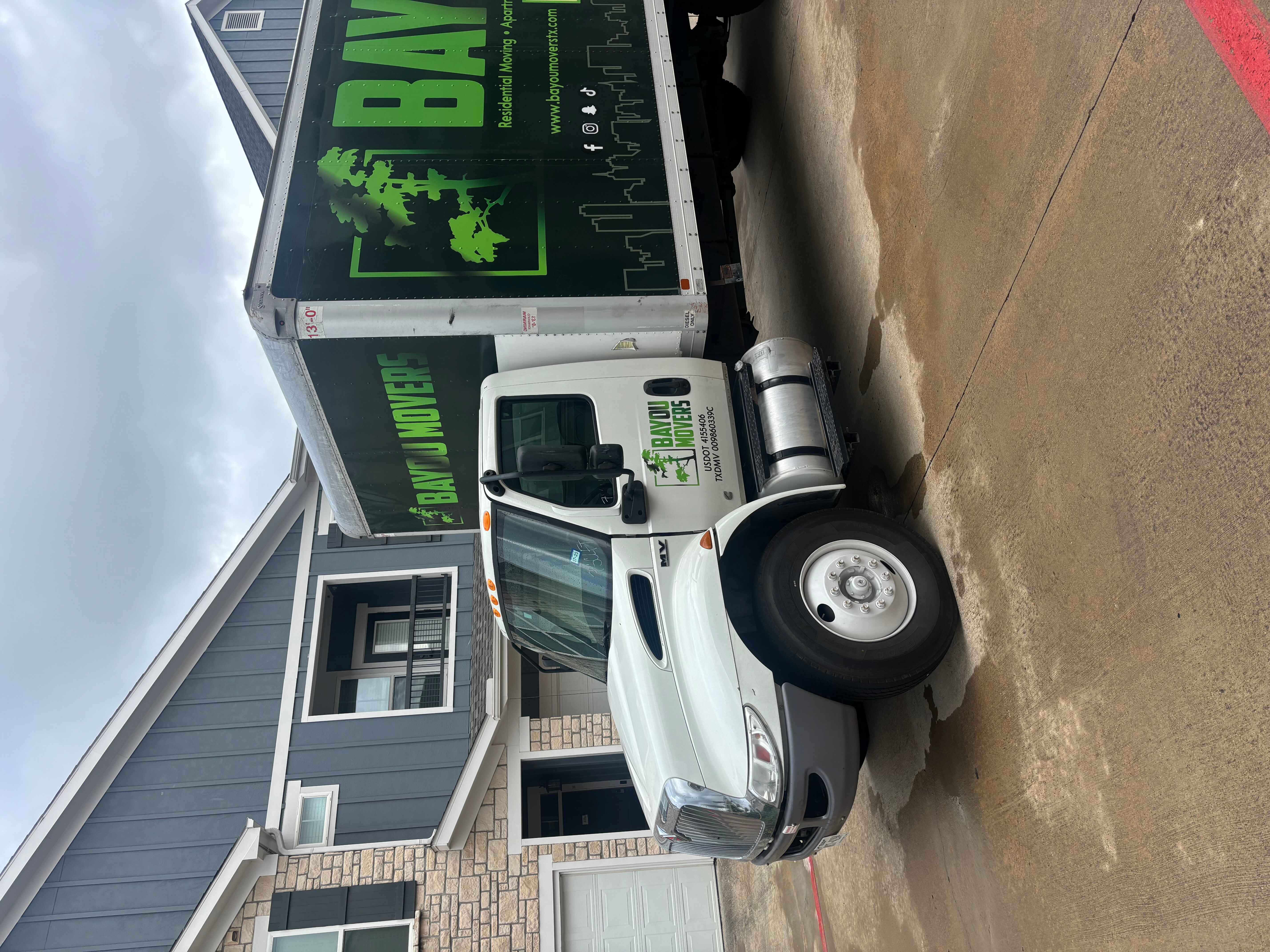 Bayou Movers truck parked on a residential driveway