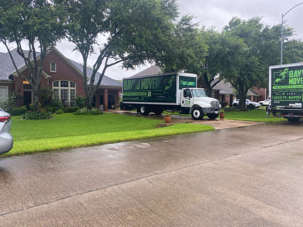Bayou Movers trucks serving a residential Houston neighborhood